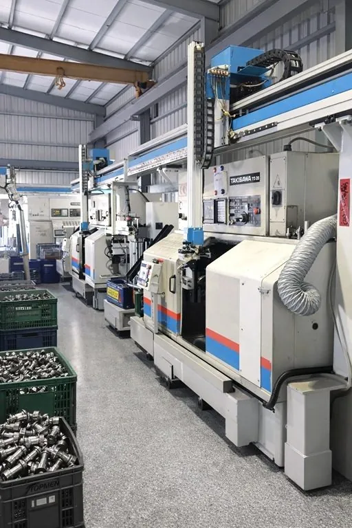 TAKISAWA CNC turning machine producing stainless steel fittings